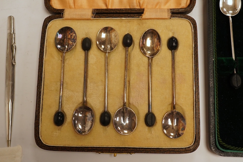 Two cased sets of six silver bean end coffee spoons, a Victorian silver bun salt, three assorted silver napkin rings, a small silver five bar toast rack and a sterling pen. Condition - poor to fair